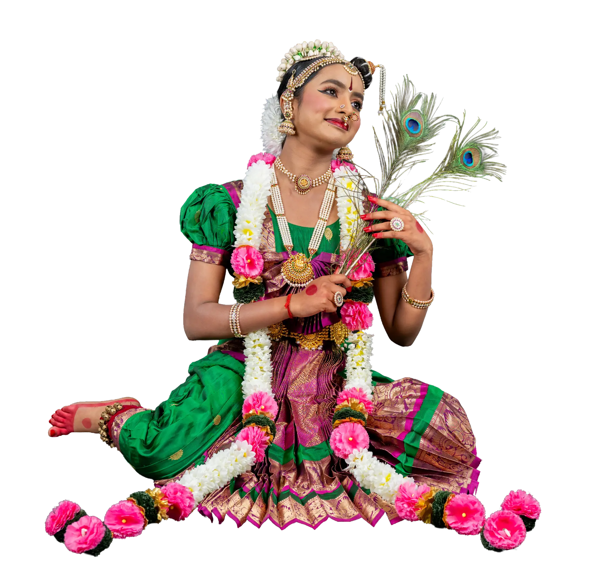 Surabhi seated with peacock feathers and garlands